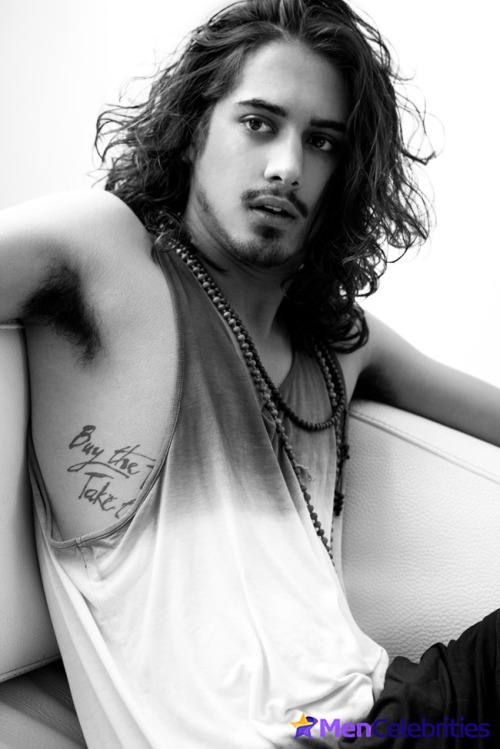 Here is Avan Jogia flaunting their nude torso, holding a... 