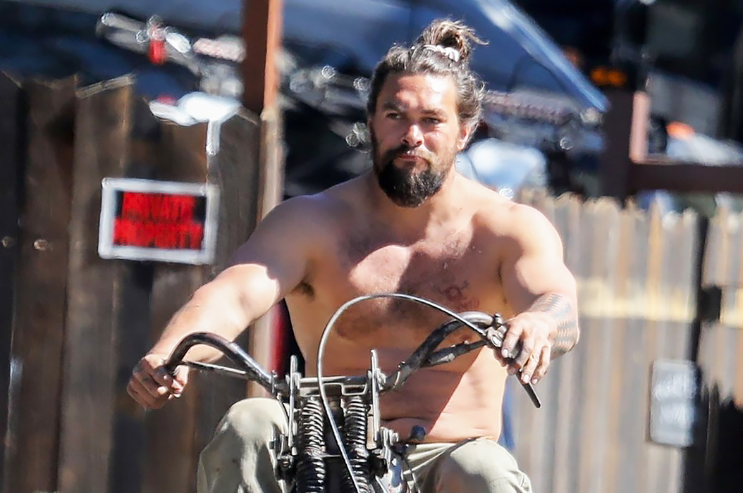 Jason Momoa shows off his naked torso while riding a motorcycle