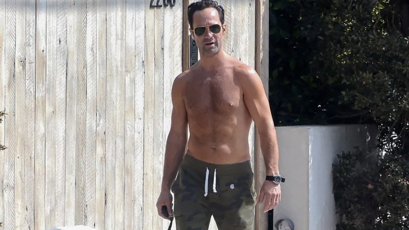 Chris Diamantopoulos showed off his hairy chest while walking his dog