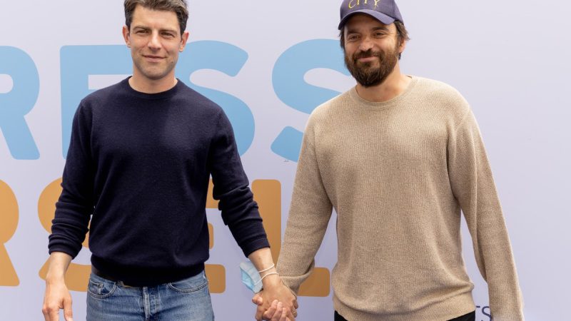 Max Greenfield and Jake Johnson hold hands at Express Yourself 2022