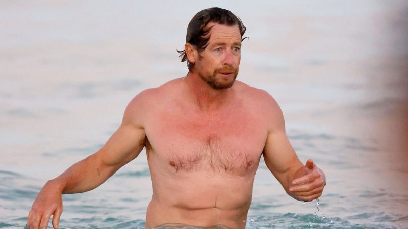 Simon Baker shirtless relaxes on the ocean with his son