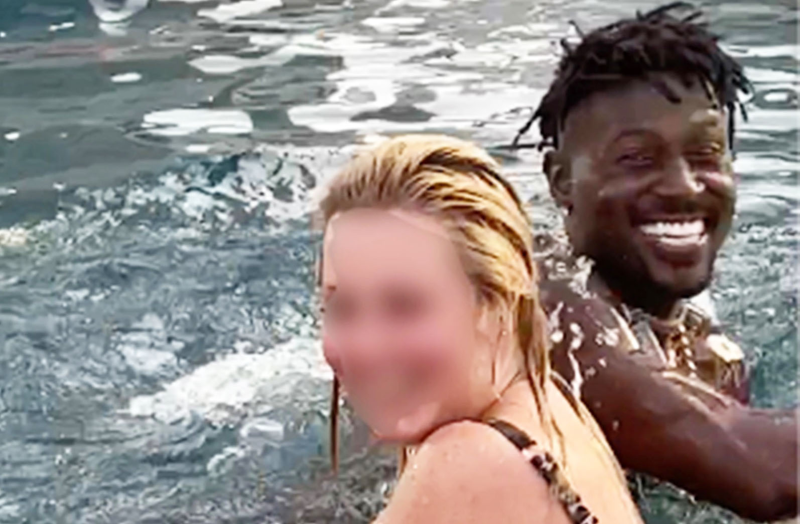 Fully naked Antonio Brown has fun with a woman in the pool