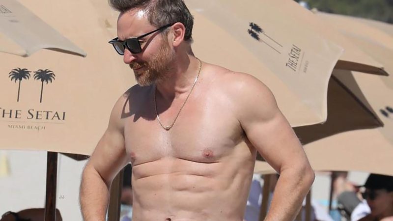 David Guetta spotted shirtless on the beach with his girlfriend