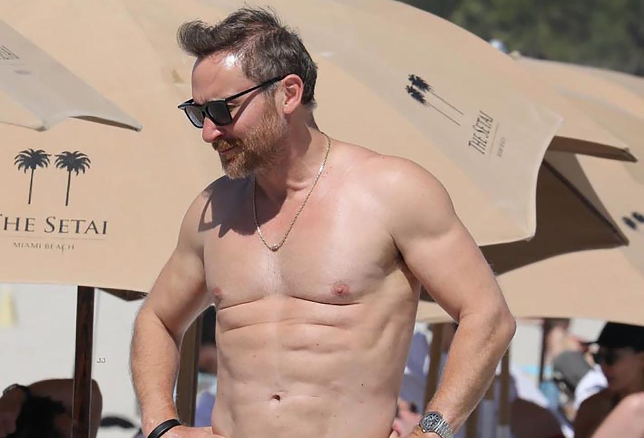 David Guetta spotted shirtless on the beach with his girlfriend