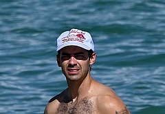Joe Jonas shirtless on a beach
