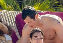 Callum Turner shirtless on beach